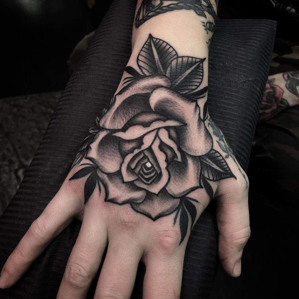 Black rose hand tattoo meaning