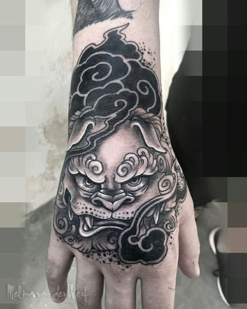 A black and gray Japanese mask hand tattoo that looks real