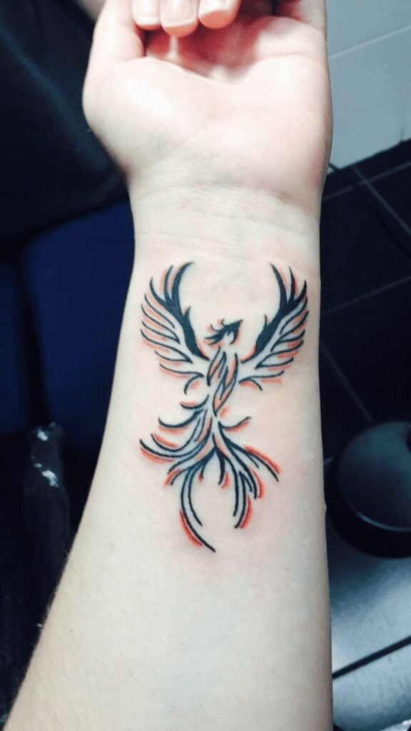 A black phoenix tattoo on the wrist