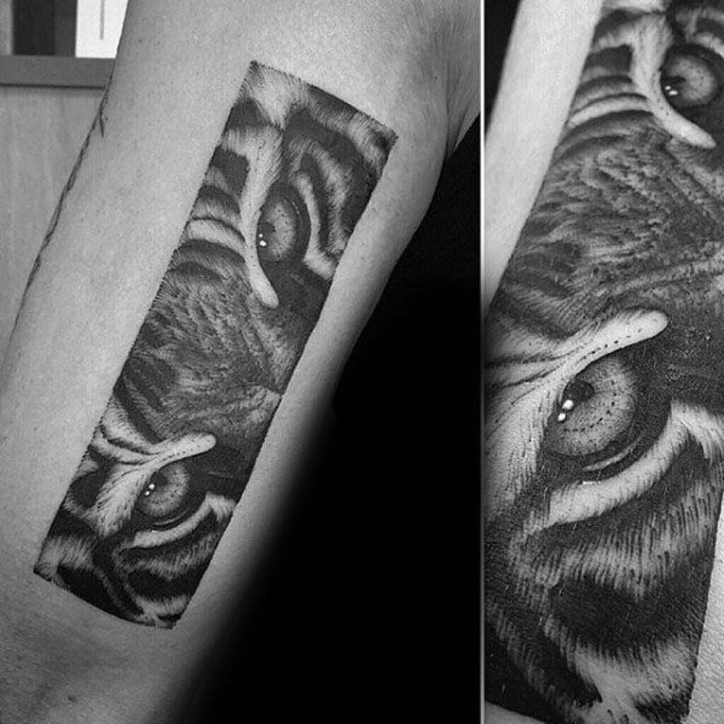 Black and grey tiger eyes tattoo on a man's hand with a bird and a dagger